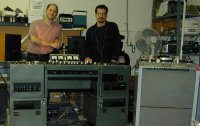 Mark and Dan Schwartz standing behind a vintage EMI Redd 37 mixing console and Studer J37 4-track recorder. The same make and model that the Beatles used to record the album “Revolver”